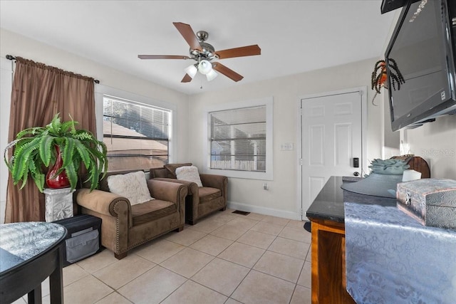 living room featuring ceiling fan and light tile patterned floors