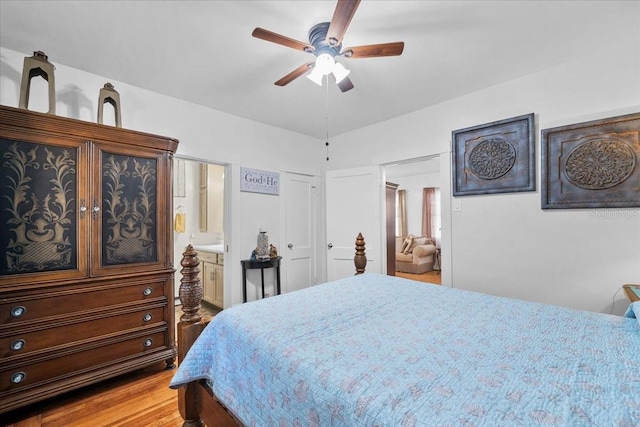 bedroom with ceiling fan, light wood-type flooring, and ensuite bath