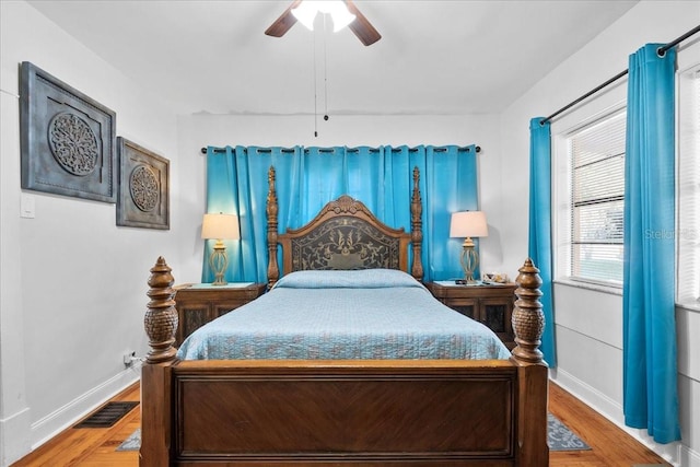 bedroom with hardwood / wood-style floors and ceiling fan