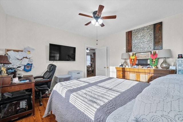 bedroom with ceiling fan and hardwood / wood-style flooring