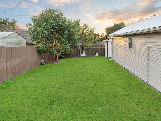 view of yard at dusk