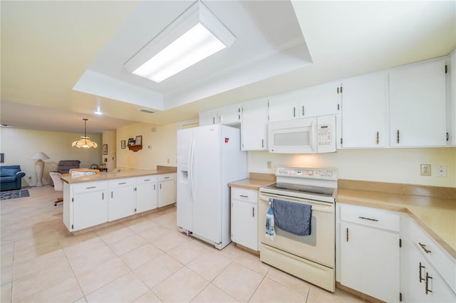 kitchen featuring pendant lighting, a raised ceiling, white appliances, and white cabinetry