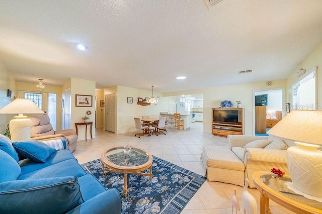 tiled living room featuring a textured ceiling