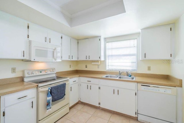 kitchen featuring white cabinets, white appliances, light tile patterned flooring, and sink