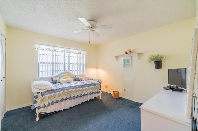 bedroom with dark carpet, a closet, ceiling fan, and a textured ceiling