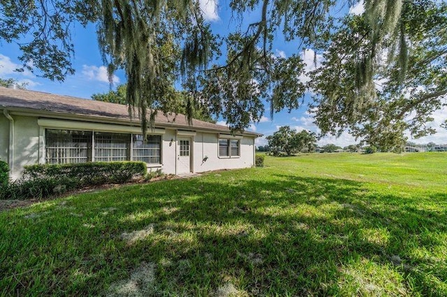 rear view of property with a yard