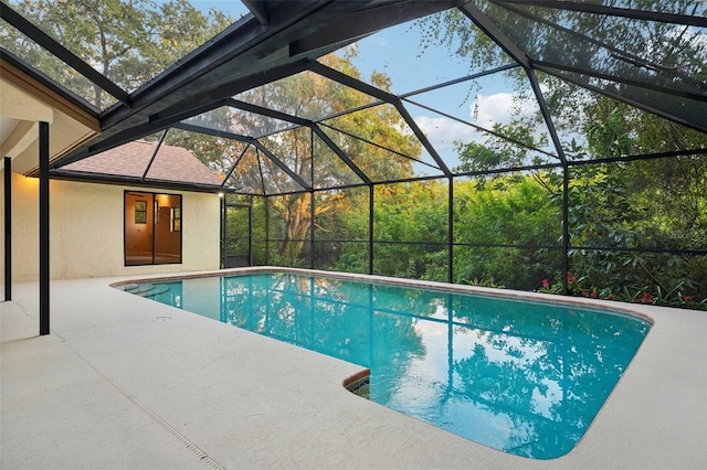 view of swimming pool with a lanai and a patio