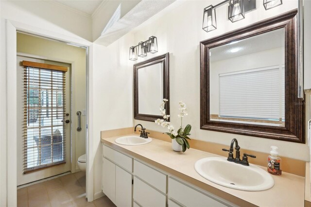 bathroom with crown molding, vanity, and toilet