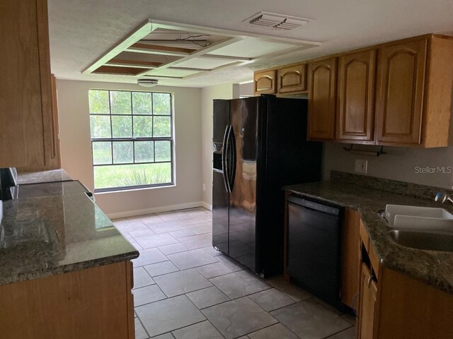 8602 Stoner Rd, Riverview, FL 33569 - kitchen with a sink, dark stone counters, black appliances, visible vents, and baseboards