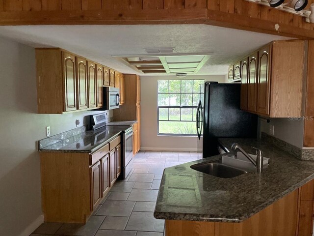 8602 Stoner Rd, Riverview, FL 33569 - kitchen with baseboards, visible vents, a sink, brown cabinets, and appliances with stainless steel finishes
