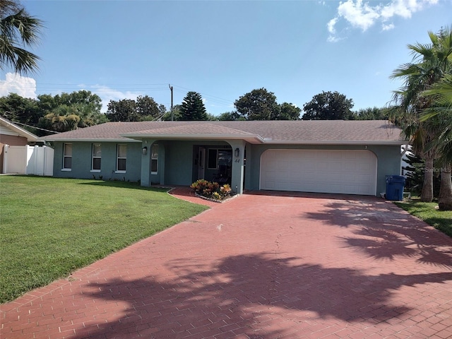 single story home with a front yard and a garage