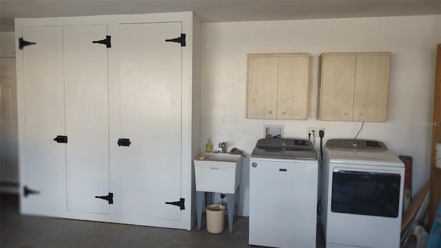 washroom with washing machine and clothes dryer and cabinets