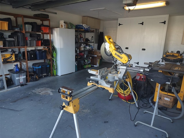 garage featuring a garage door opener and white fridge