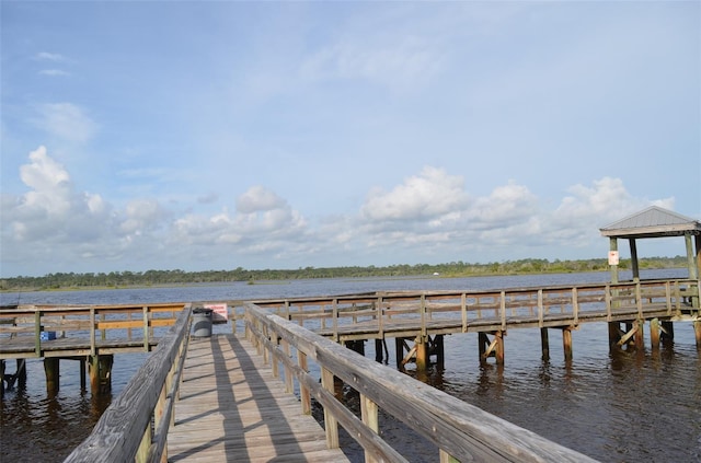 view of dock featuring a gazebo and a water view