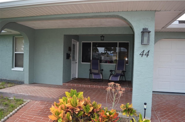 doorway to property with a garage