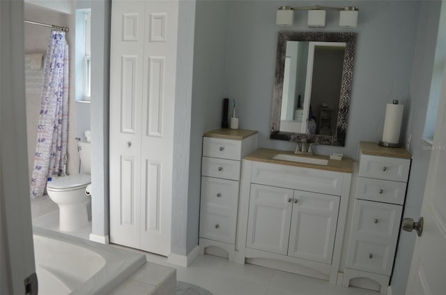 bathroom with a shower with curtain, vanity, tile patterned flooring, and toilet