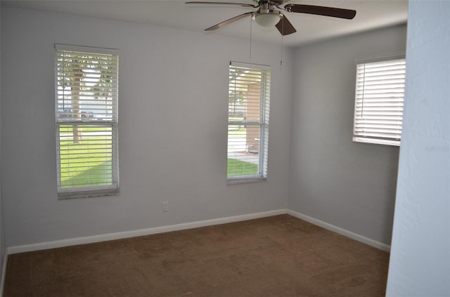 unfurnished room featuring ceiling fan and carpet flooring