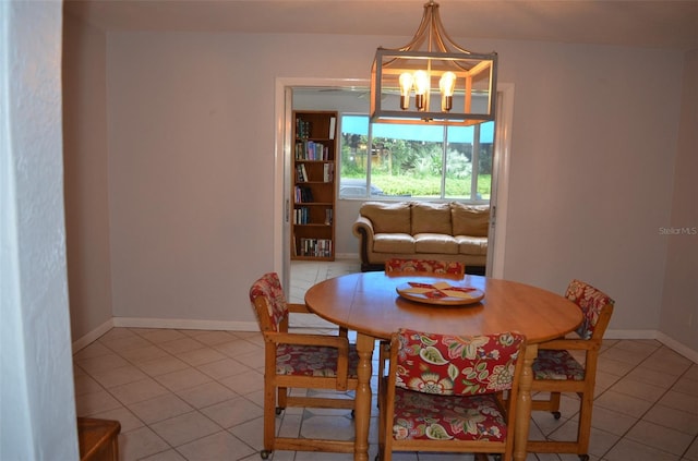 tiled dining space with an inviting chandelier