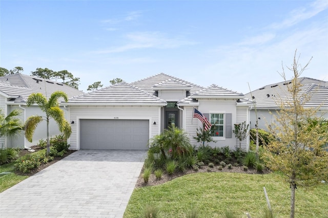 view of front of property with a garage and a front lawn