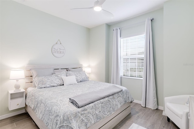 bedroom with light hardwood / wood-style floors and ceiling fan