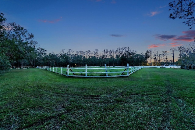 view of property's community featuring a lawn and a rural view