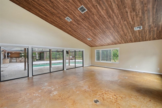 empty room featuring a healthy amount of sunlight, wood ceiling, and a high ceiling