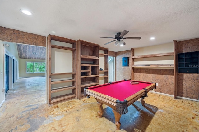 playroom with ceiling fan, concrete flooring, a textured ceiling, and pool table