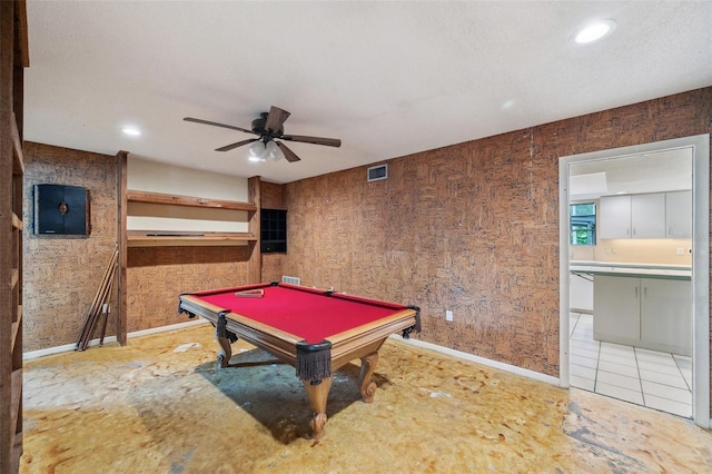 game room featuring ceiling fan, wooden walls, and billiards