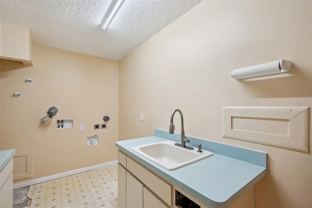 laundry area featuring cabinets, washer hookup, a textured ceiling, and sink