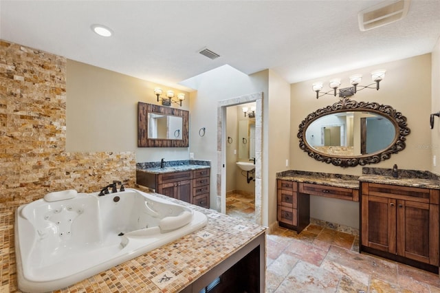 bathroom featuring tiled bath and vanity