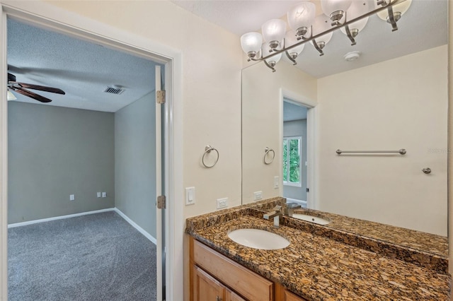 bathroom featuring vanity, a textured ceiling, and ceiling fan