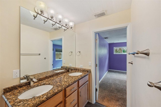 bathroom featuring vanity and a textured ceiling