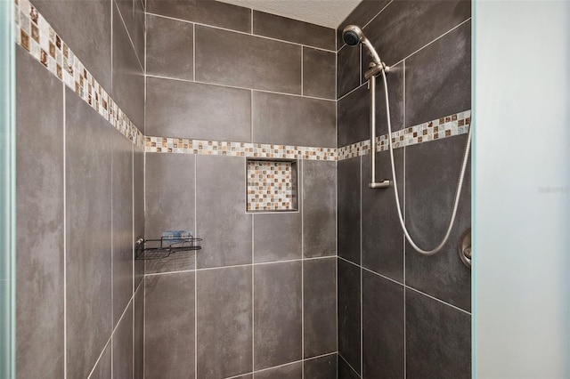 bathroom with a tile shower