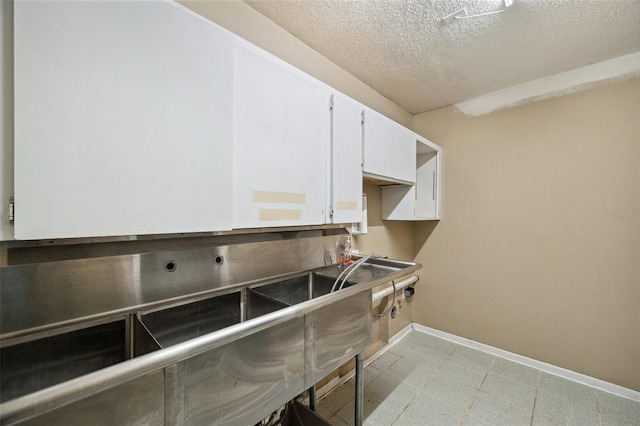 washroom featuring electric dryer hookup and a textured ceiling