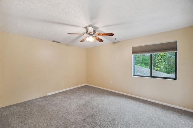 empty room featuring ceiling fan, carpet floors, and a textured ceiling