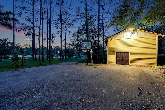 view of garage at dusk