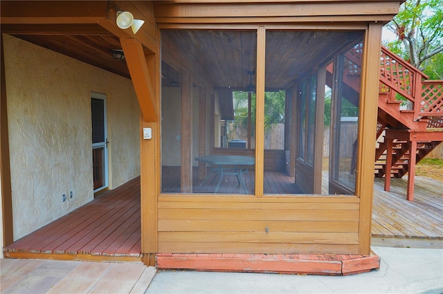 wooden deck featuring a sunroom