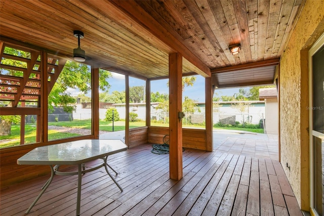 unfurnished sunroom with a wealth of natural light and wooden ceiling