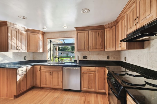 kitchen with dishwasher, dark stone counters, sink, black range with electric cooktop, and light hardwood / wood-style floors