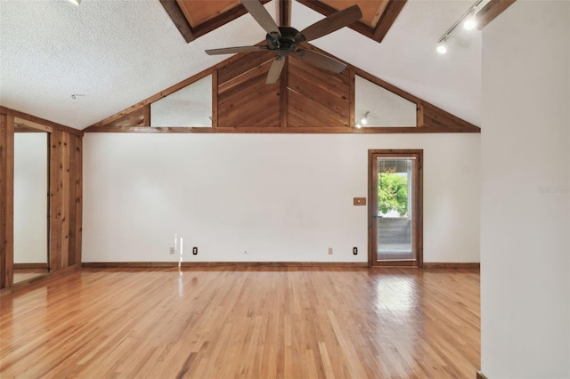 unfurnished living room featuring ceiling fan, light hardwood / wood-style flooring, high vaulted ceiling, and a textured ceiling