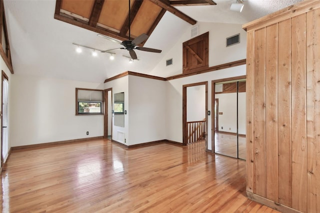 spare room with beamed ceiling, ceiling fan, high vaulted ceiling, and light hardwood / wood-style flooring