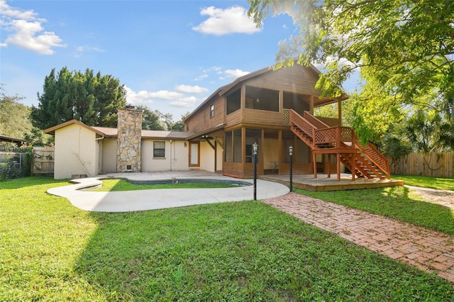 rear view of property featuring a yard and a patio