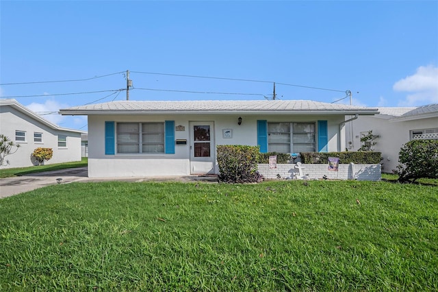 single story home featuring stucco siding and a front lawn
