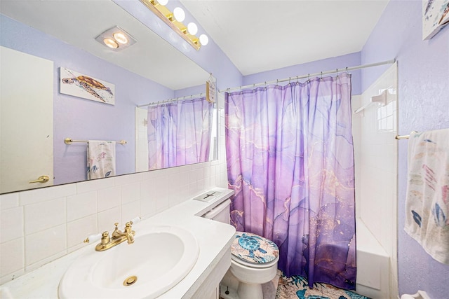 full bathroom with backsplash, toilet, shower / bath combo with shower curtain, and vanity
