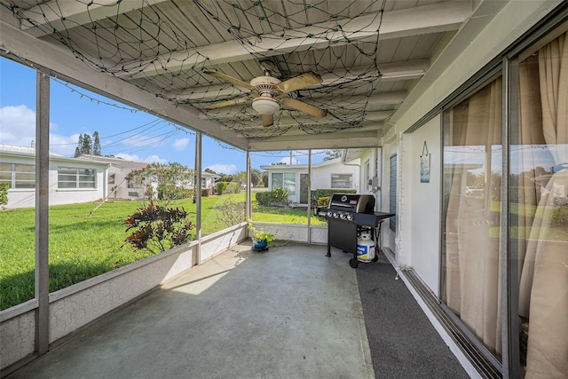 unfurnished sunroom with ceiling fan