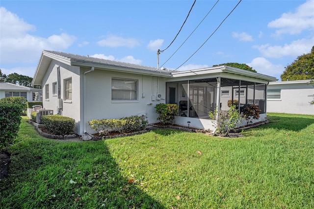 view of front of home featuring a sunroom and a front yard