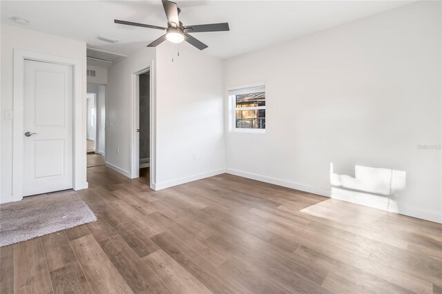 unfurnished room with ceiling fan and wood-type flooring