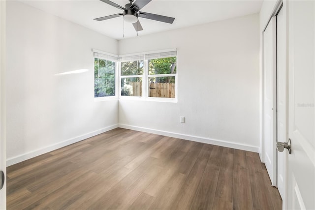 unfurnished bedroom featuring a closet, wood-type flooring, and ceiling fan