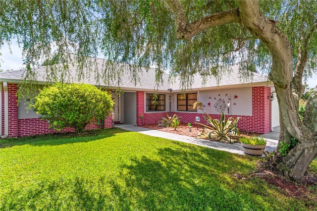 single story home featuring a front yard and a garage