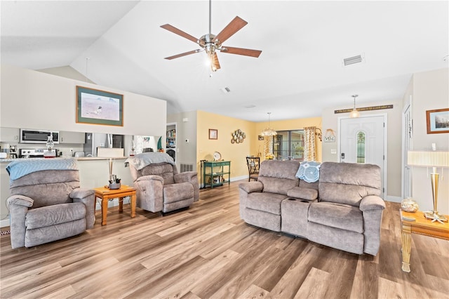 living room with ceiling fan, light hardwood / wood-style floors, and lofted ceiling